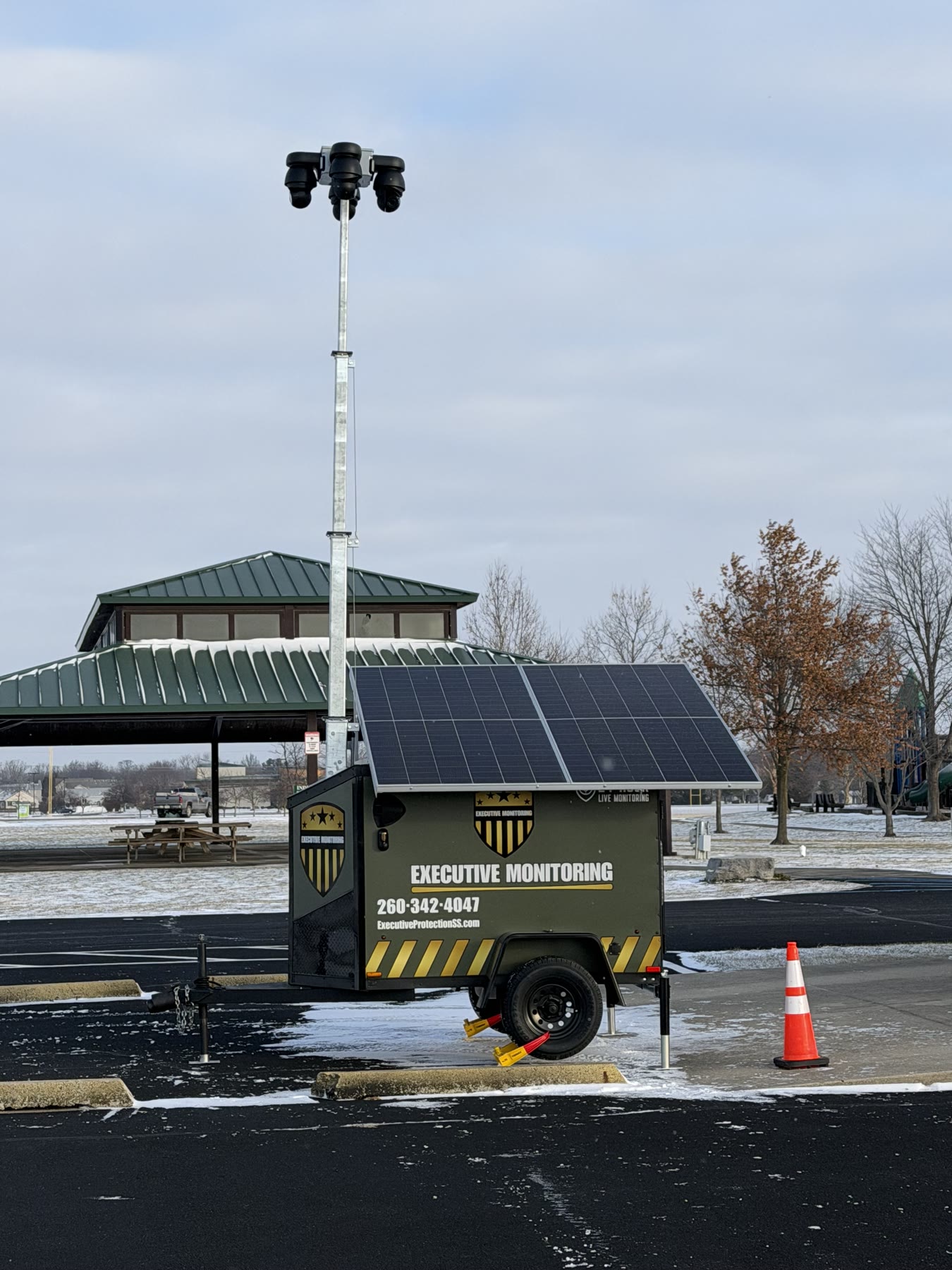 Executive Monitoring surveillance trailer on station at a public park pavilion, camera mast raised