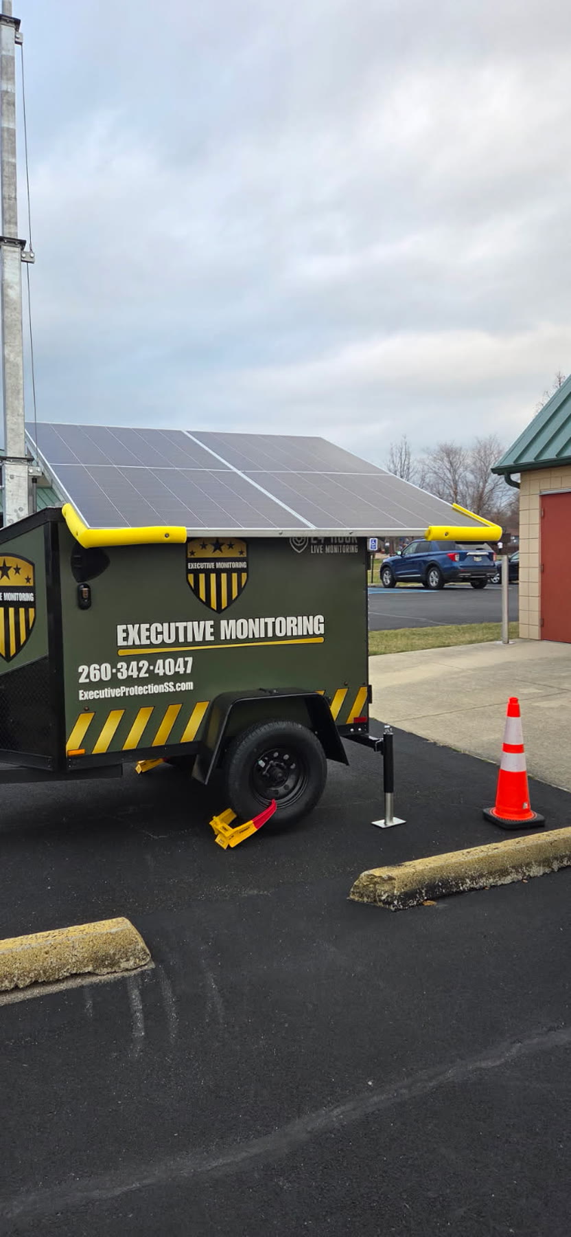 Branded Executive Monitoring solar-powered surveillance trailer staged and ready