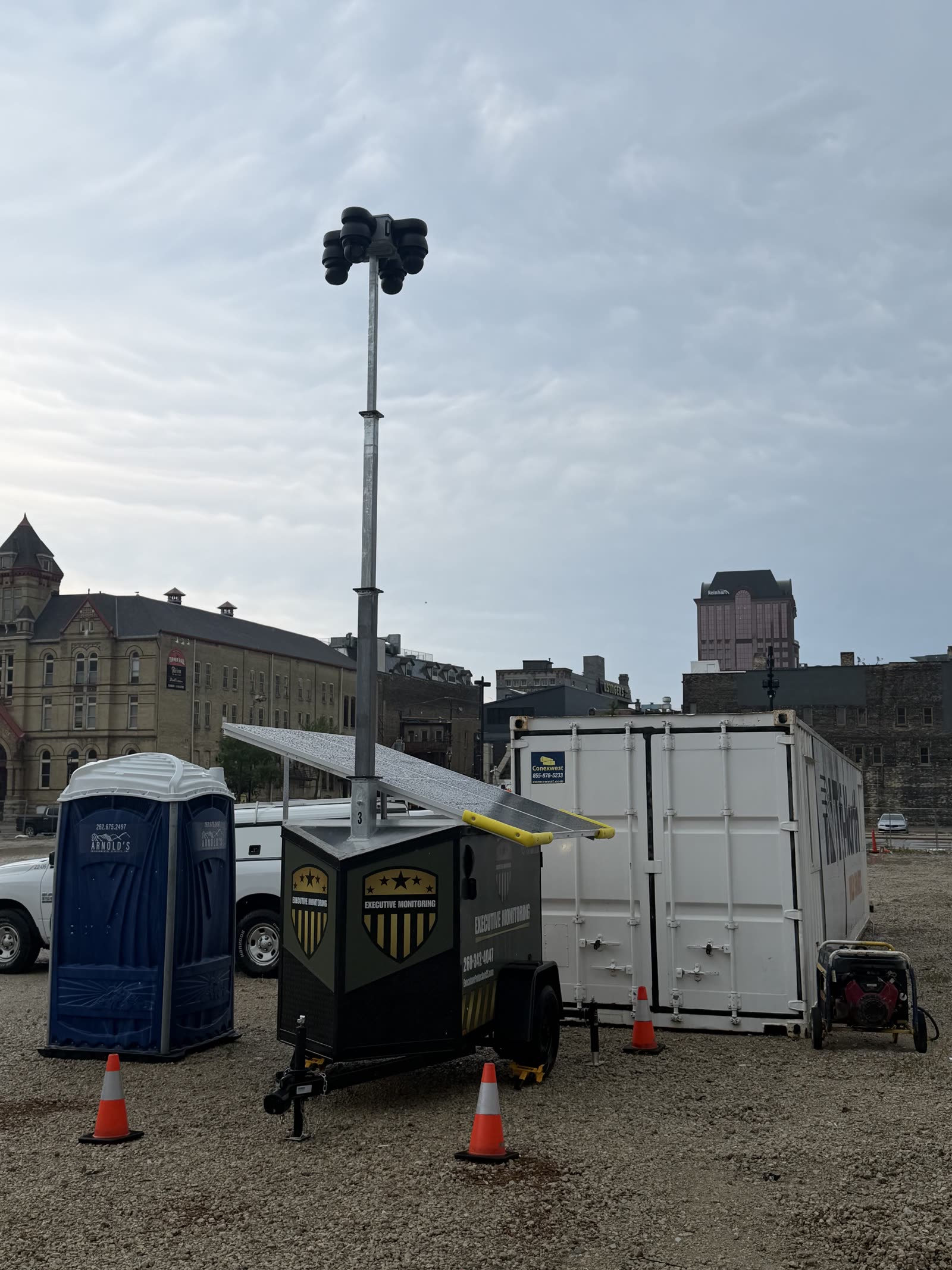 Executive Monitoring solar surveillance trailer standing watch with the Milwaukee skyline behind it